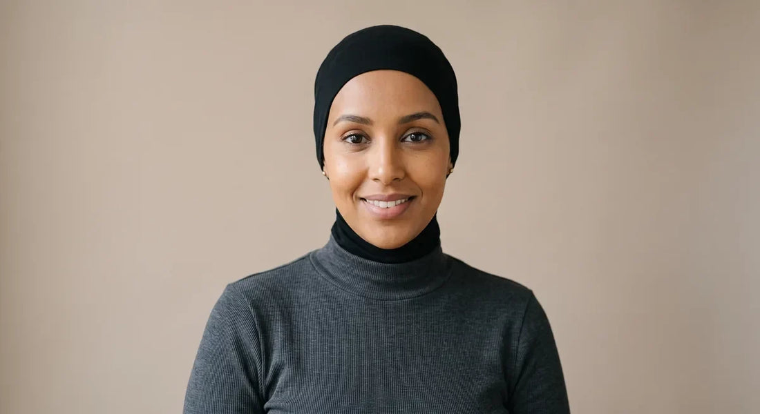 Woman wearing a black jersey hijab cap that covers her hairline