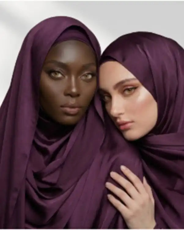 Two women wearing purple chiffon hijabs