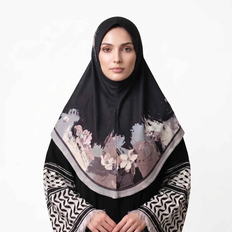 Woman wearing a black floral instant hijab, front view — one piece slip on hijab with blush pink and ivory watercolor flower border