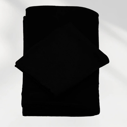 Black jersey hijab and matching hijab cap laid flat, showing the soft stretch fabric