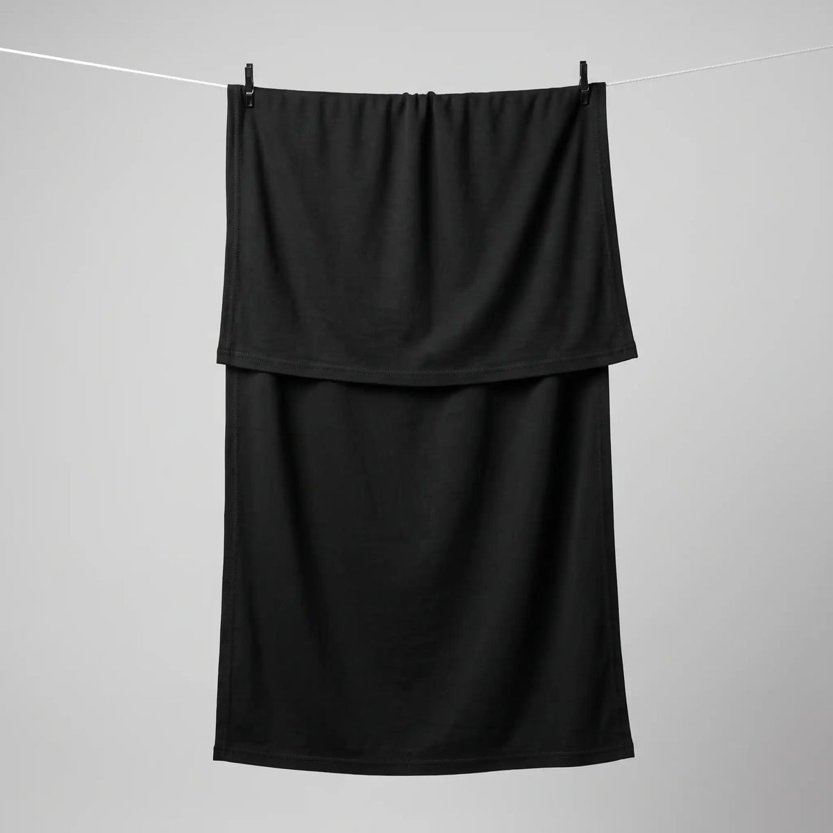 Full length black jersey hijab hanging on a line