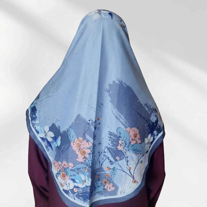 Back view of blue floral instant hijab showing the draped panel with coral peach and ivory watercolor floral border
