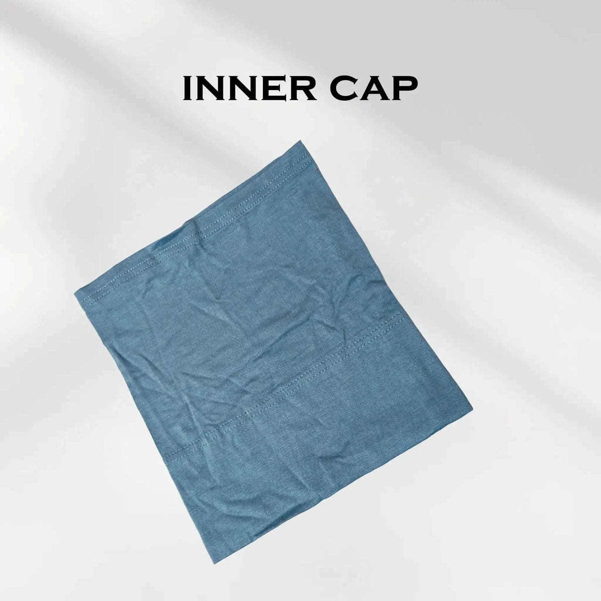 Blue hijab cap folded flat, the non-slip cap included with every modal hijab
