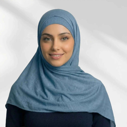 Woman wearing a blue modal hijab draped loosely over the shoulders