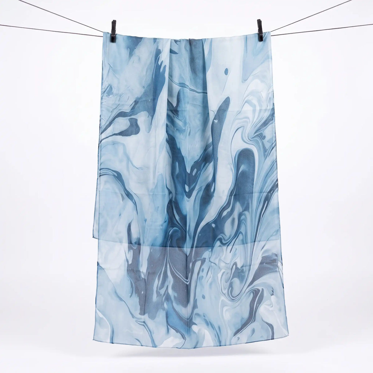 Full length blue printed modal hijab hanging on a line, showing the pattern across the scarf