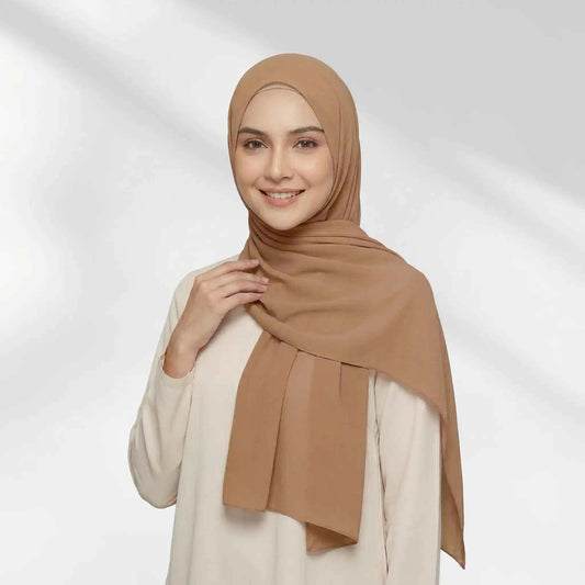 Woman wearing a brown chiffon hijab set with a matching jersey hijab undercap.