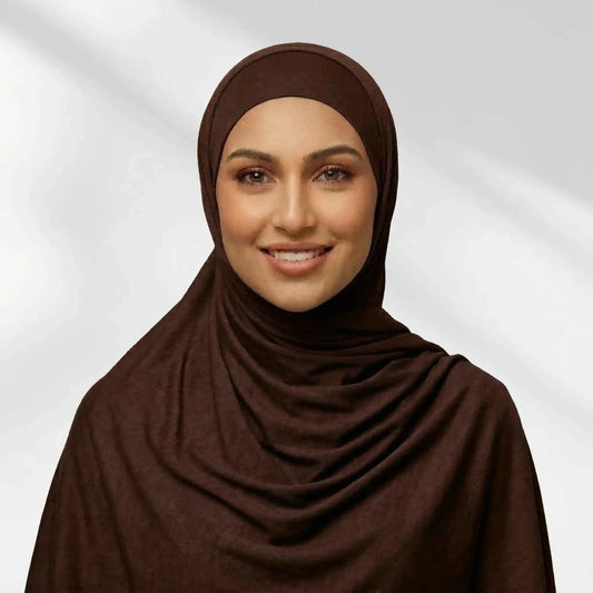 Woman wearing a brown jersey hijab draped for full chest coverage, front view