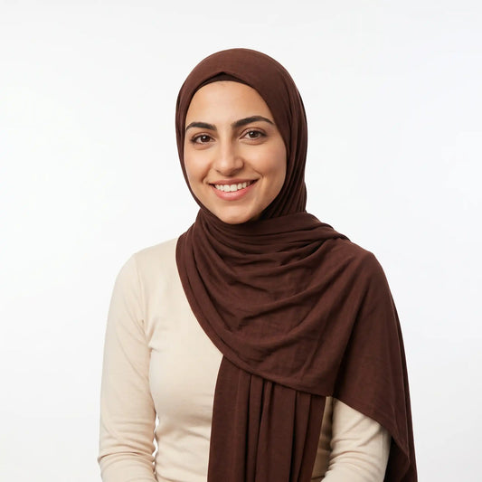 Woman wearing a brown jersey hijab with a cream top