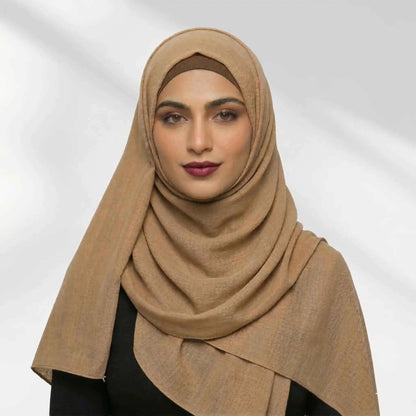 Woman wearing a brown modal hijab styled over a matching hijab undercap
