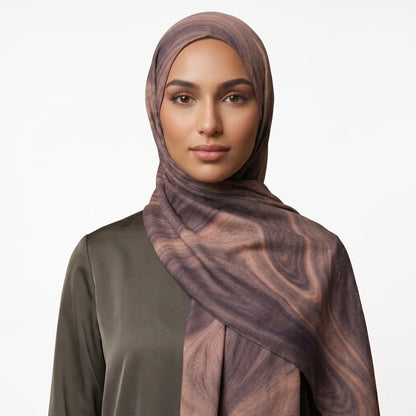 Woman wearing a brown printed modal hijab with an olive top