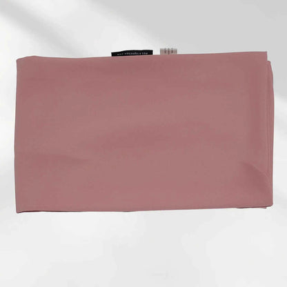 Folded pink chiffon hijab scarf laid flat displaying smooth fabric texture and finished stitched edges.