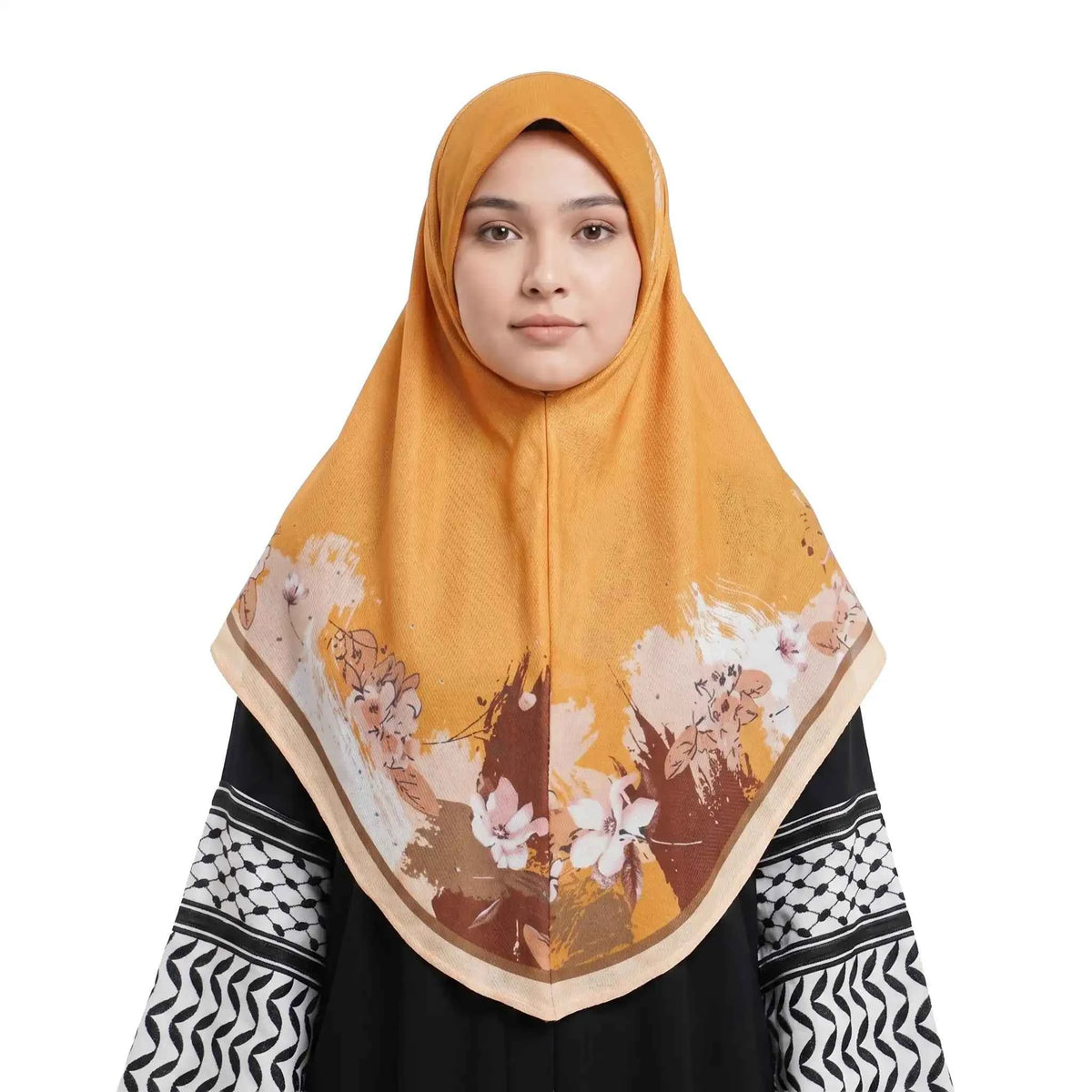 Woman wearing a gold floral instant hijab, front view — one piece slip on gold hijab with a painted floral border and cream trim
