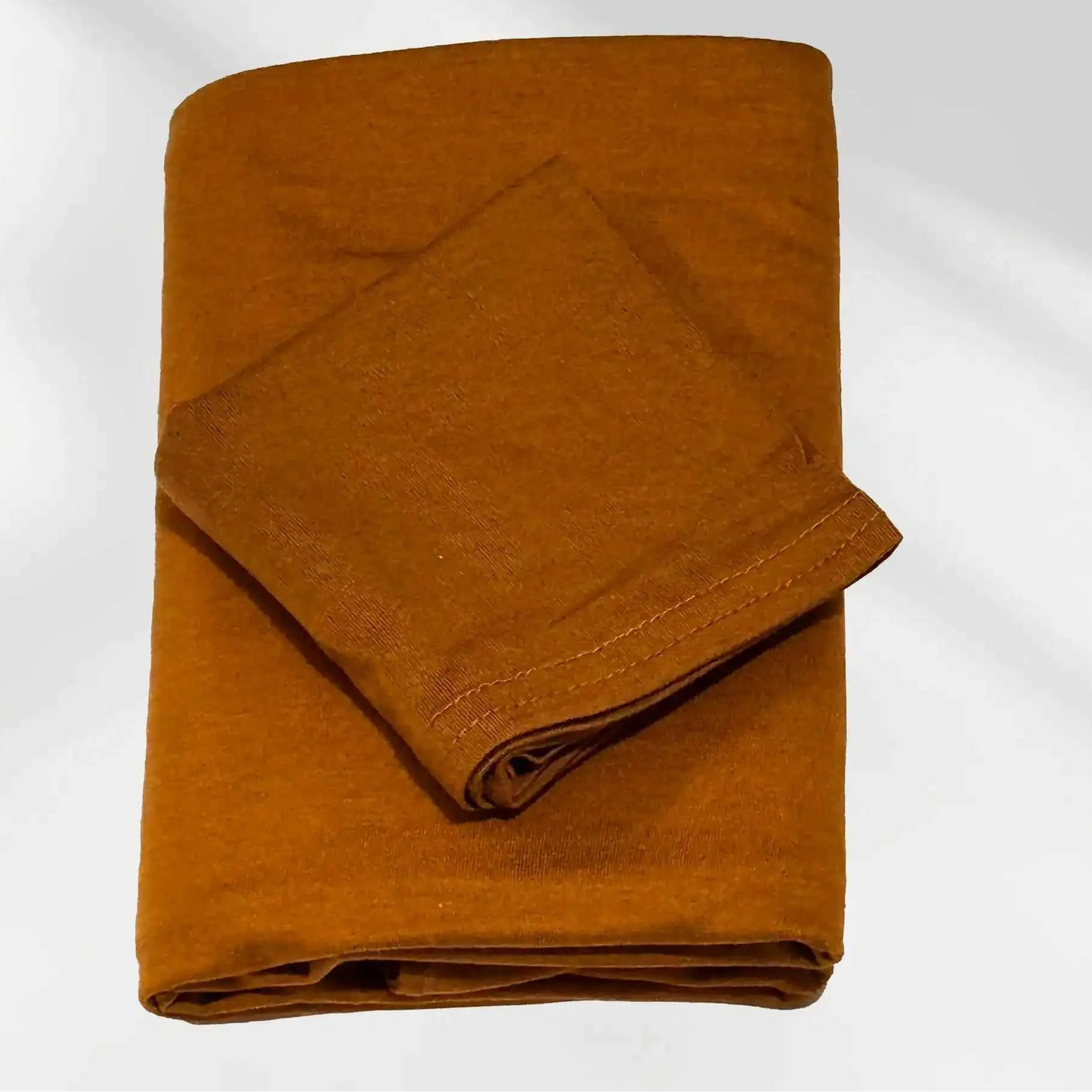 Gold jersey hijab and matching hijab cap laid flat, showing the soft stretch fabric and stitched cap edge