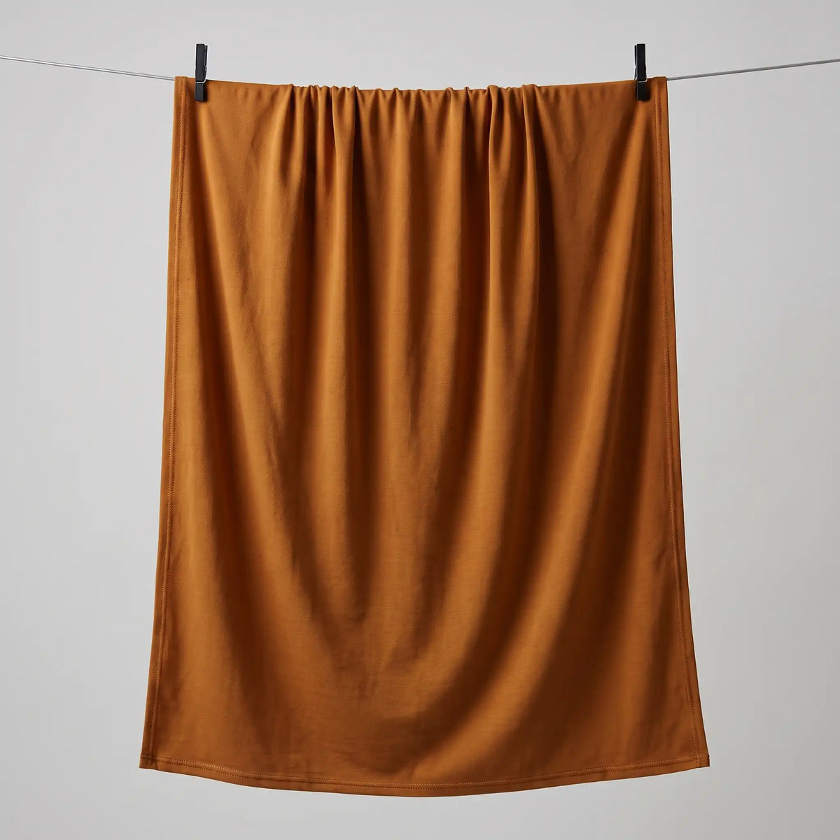 Full length gold jersey hijab hanging on a line