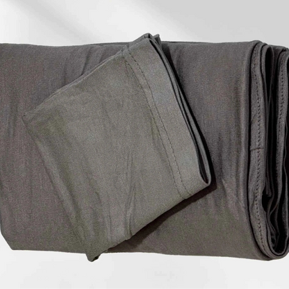 Gray jersey hijab folded with its matching hijab cap, shown as a complete set