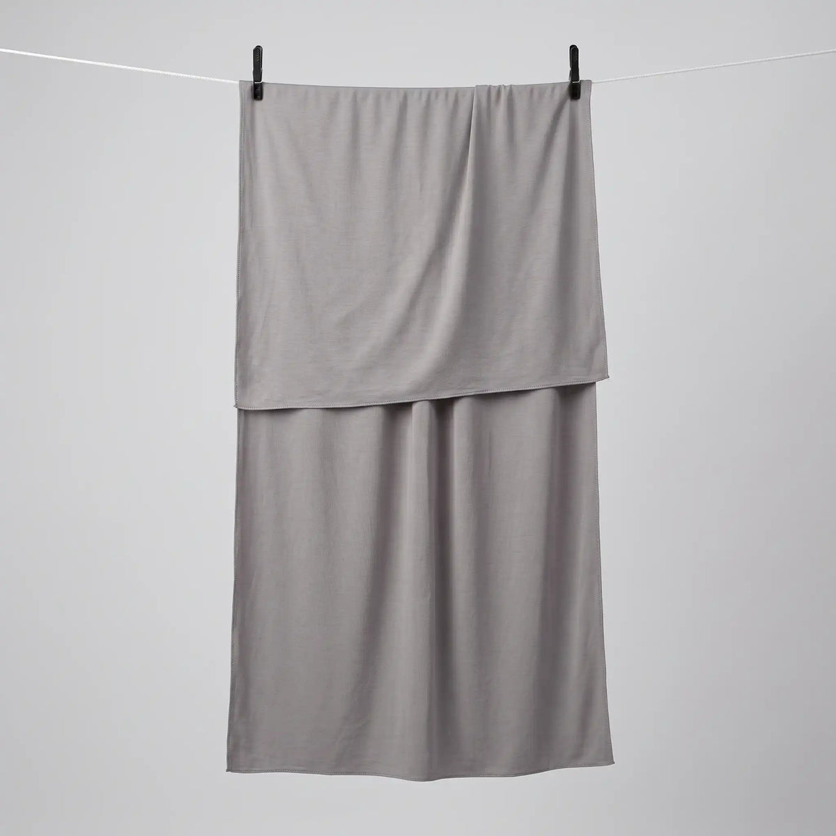 Full length grey jersey hijab hanging on a line