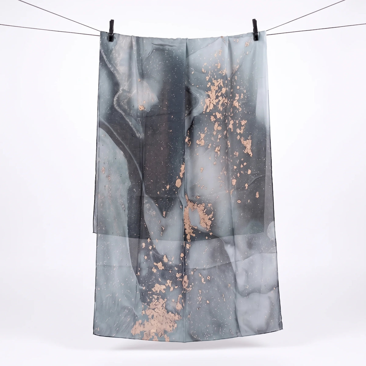 Full length grey printed modal hijab hanging on a line, showing the charcoal and rose gold print