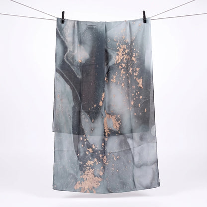Full length grey printed modal hijab hanging on a line, showing the charcoal and rose gold print