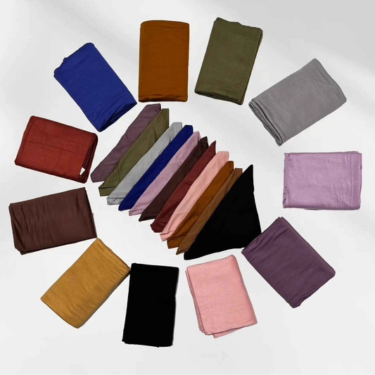 Cotton jersey hijabs and matching hijab caps shown folded in blue, red, olive green, grey, maroon, pink, black, gold, brown and burgundy