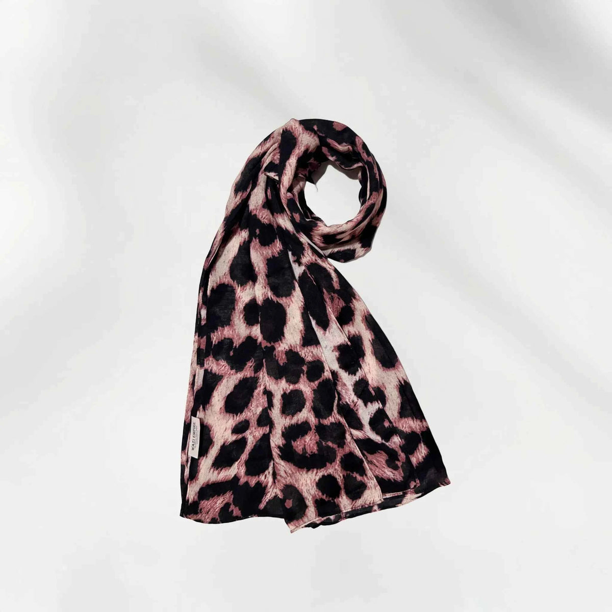 Leopard print modal hijab coiled to show the lightweight drape and animal print