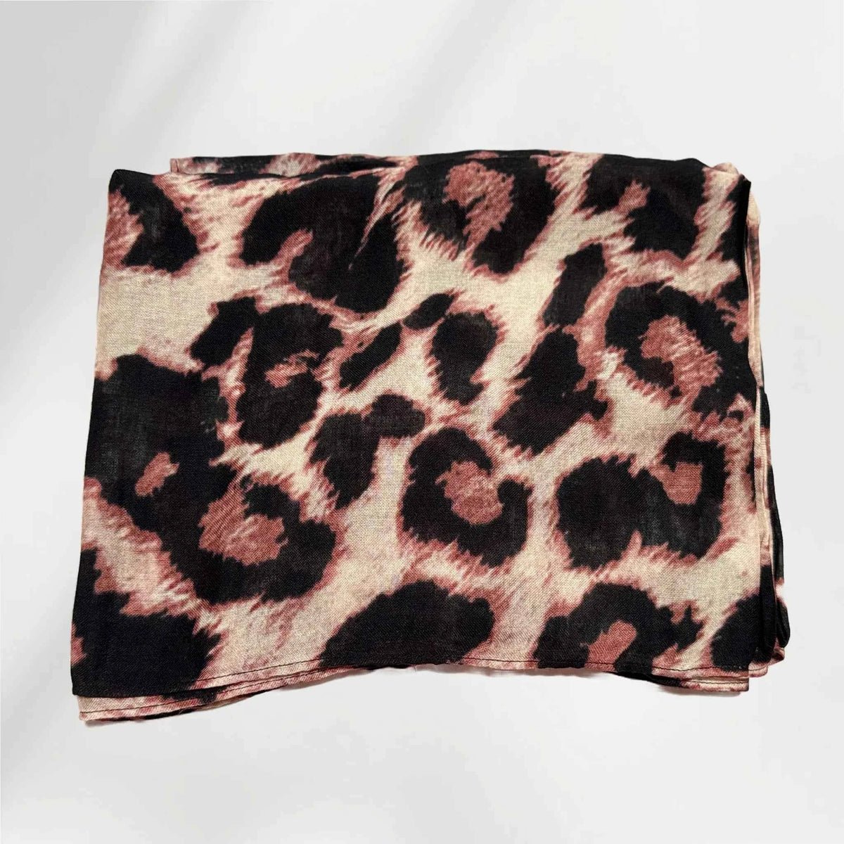 Folded leopard print modal hijab showing the brown and black spot pattern