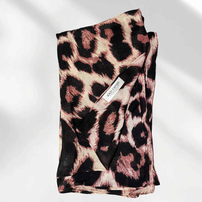 Folded leopard print modal hijab with the Wazi Empire woven label visible
