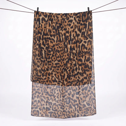 Full length hijab leopard print hanging on a line, showing black rosettes on a tan base