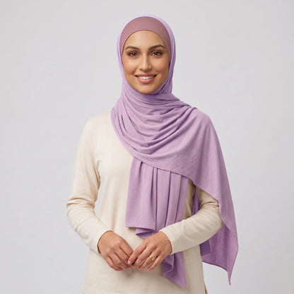 Woman wearing a light purple jersey hijab over a dusty pink hijab cap