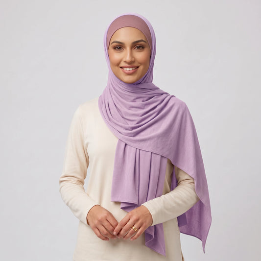 Woman wearing a light purple jersey hijab over a dusty pink hijab cap