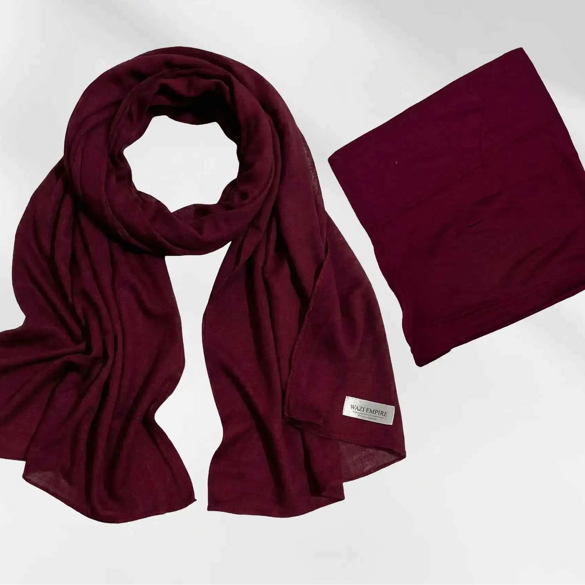 Maroon modal hijab and matching hijab cap shown together as a complete set, with the Wazi Empire label visible