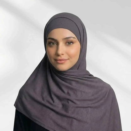 Woman wearing a mauve grey modal hijab draped over the shoulder with a matching undercap underneath