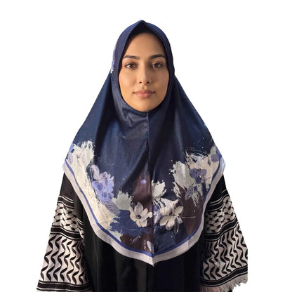 Woman wearing a navy blue floral instant hijab, front view — one piece slip on hijab with periwinkle and ivory watercolor flower border