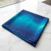 Folded blue ombre printed modal hijab in cobalt and teal on white marble