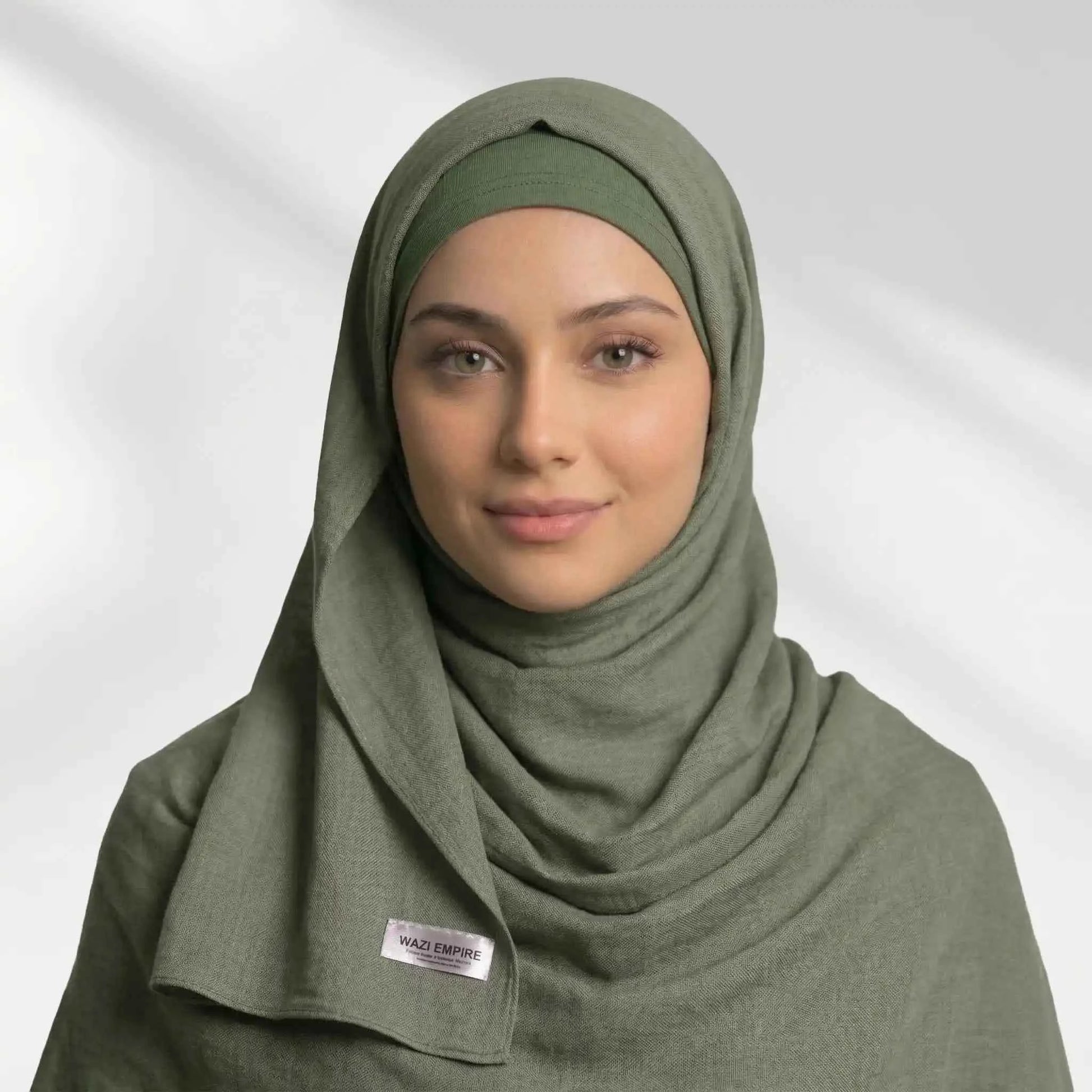 Woman wearing an olive green modal hijab over a matching hijab undercap