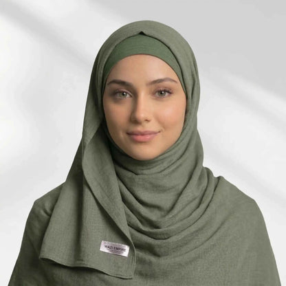 Woman wearing an olive green modal hijab over a matching hijab undercap