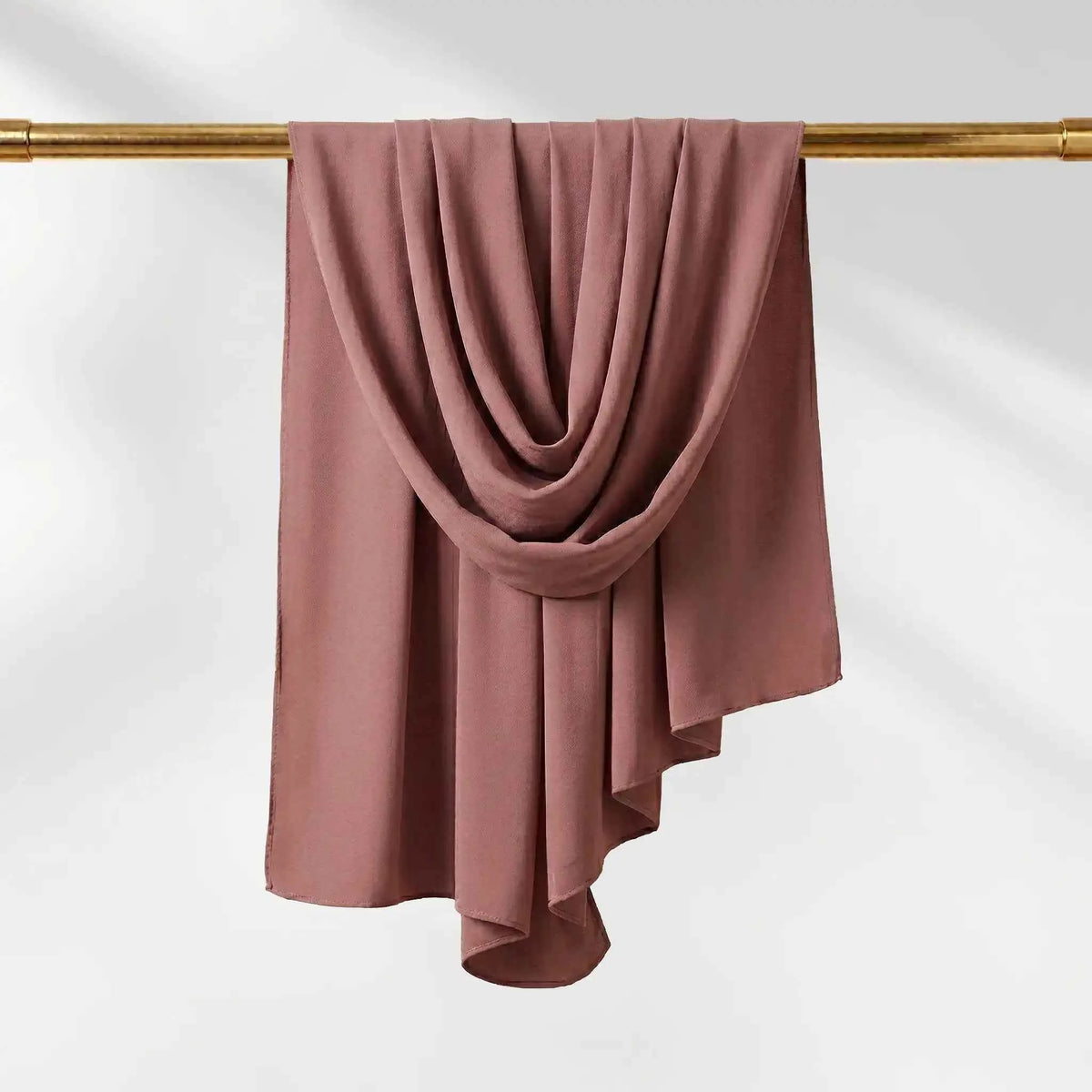 Pink chiffon hijab in a dusty rose shade, shown to display the soft muted tone