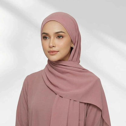 Woman wearing the pink chiffon hijab set with a matching jersey undercap, front view.