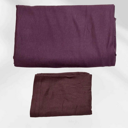 Purple jersey hijab and matching hijab cap laid flat, showing the soft stretch fabric and stitched cap edge