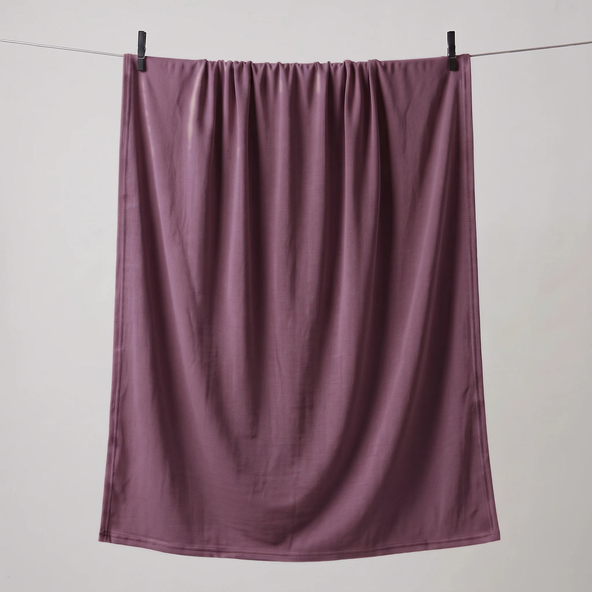 Full length purple jersey hijab hanging on a line