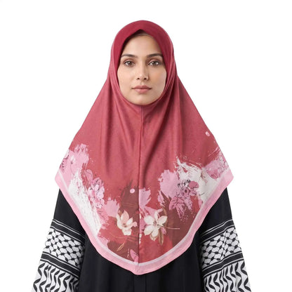 Woman wearing a red floral instant hijab, front view — one piece square hijab in berry red with a blush pink and ivory watercolor flower border.