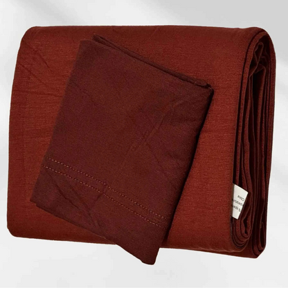 Rust red jersey hijab folded with its matching hijab cap, shown as a complete set