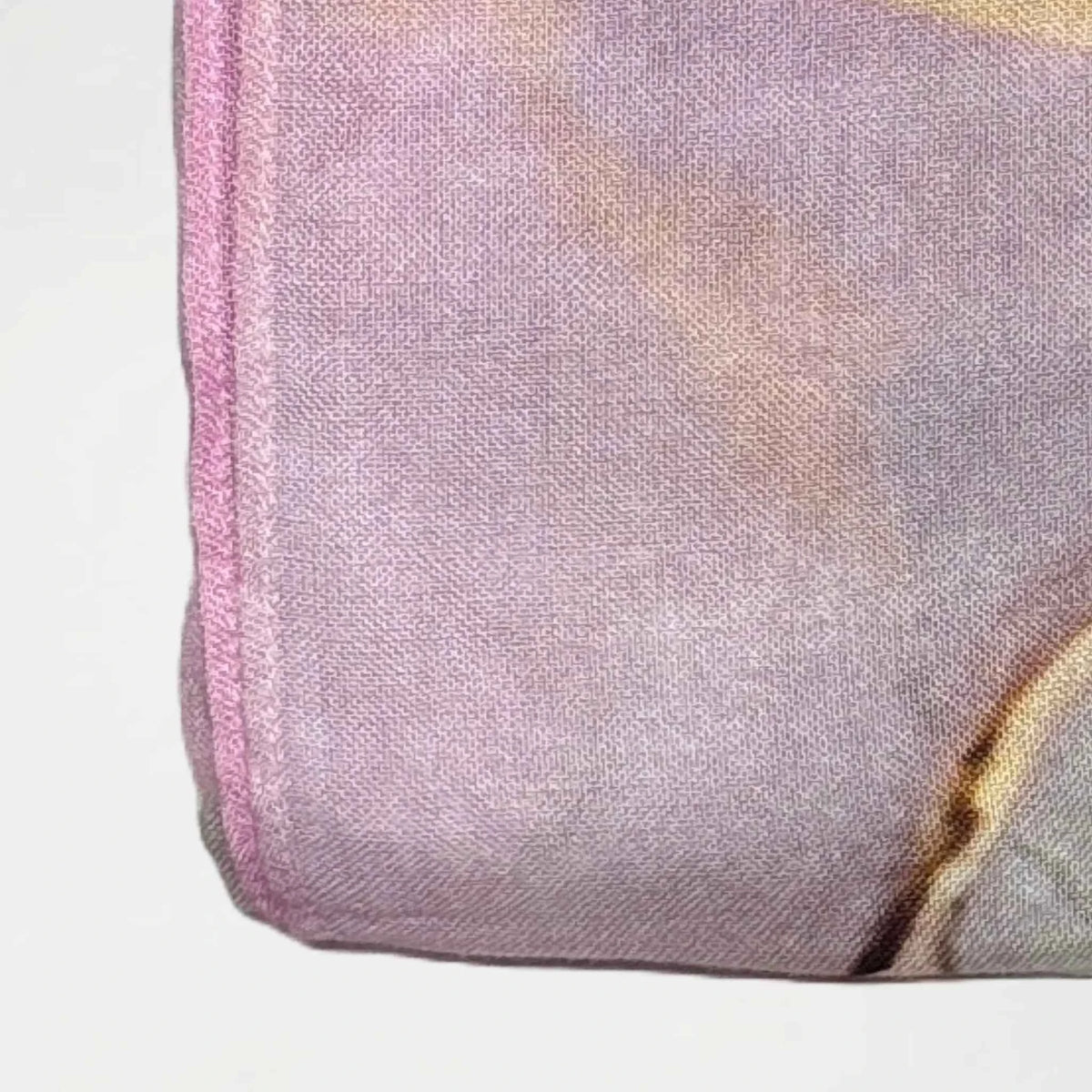 Close view of the watercolor printed modal hijab showing the pastel wash and stitched edge