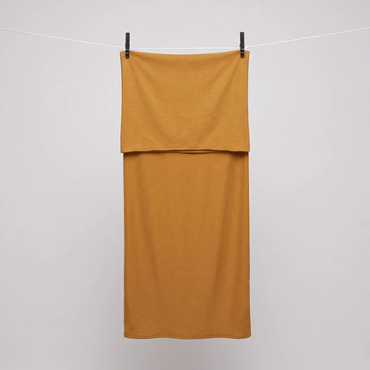 Full length yellow jersey hijab hanging on a line, warm golden yellow